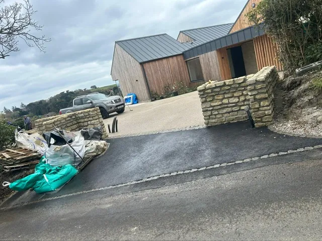 Tarmac driveway with stone retaining walls in Kent