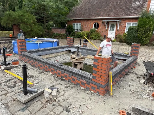 Brick pond wall construction in progress in Kent