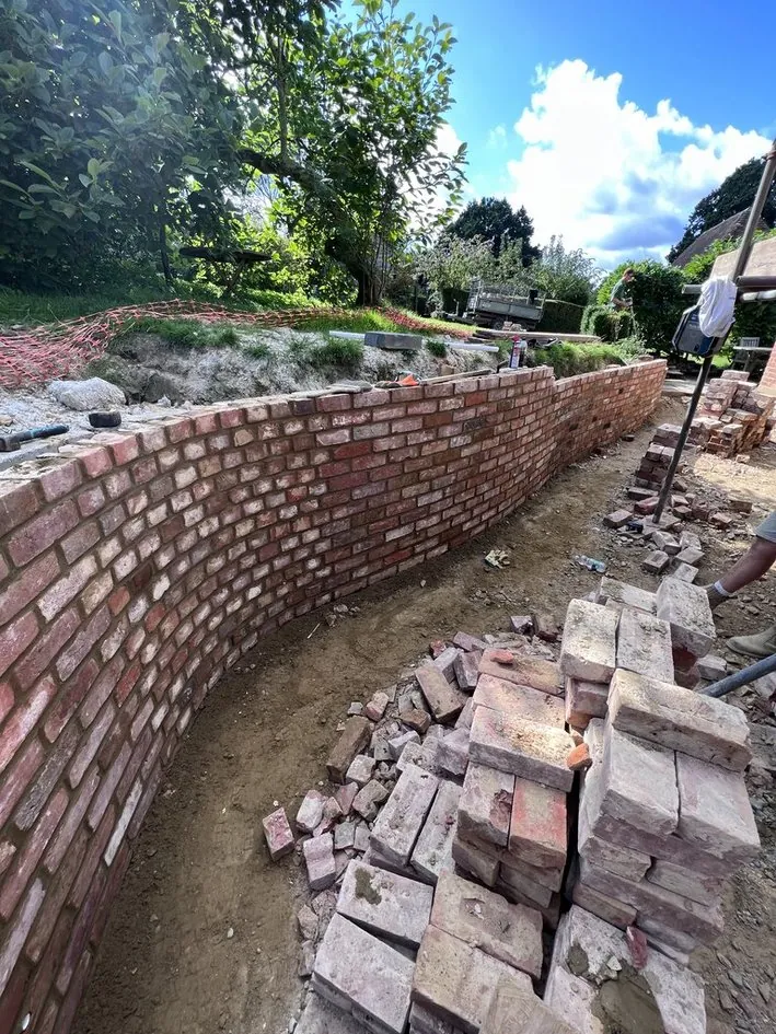 Professional brick retaining wall with raised patio in Kent